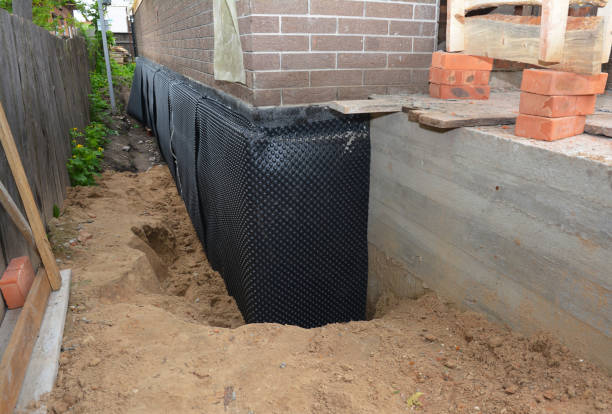 SJ Waterproofing Pros technician performing targeted Exterior Waterproofing assessment in Monticello, IL